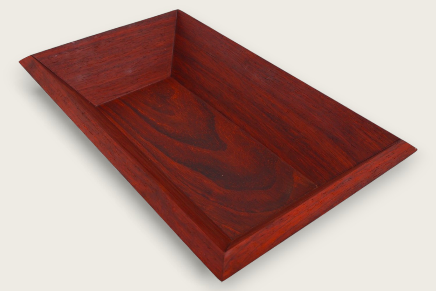 Padauk catch-all bowl with horizontal face grain, rectangular shape, warm reddish tones, and a tung oil finish.